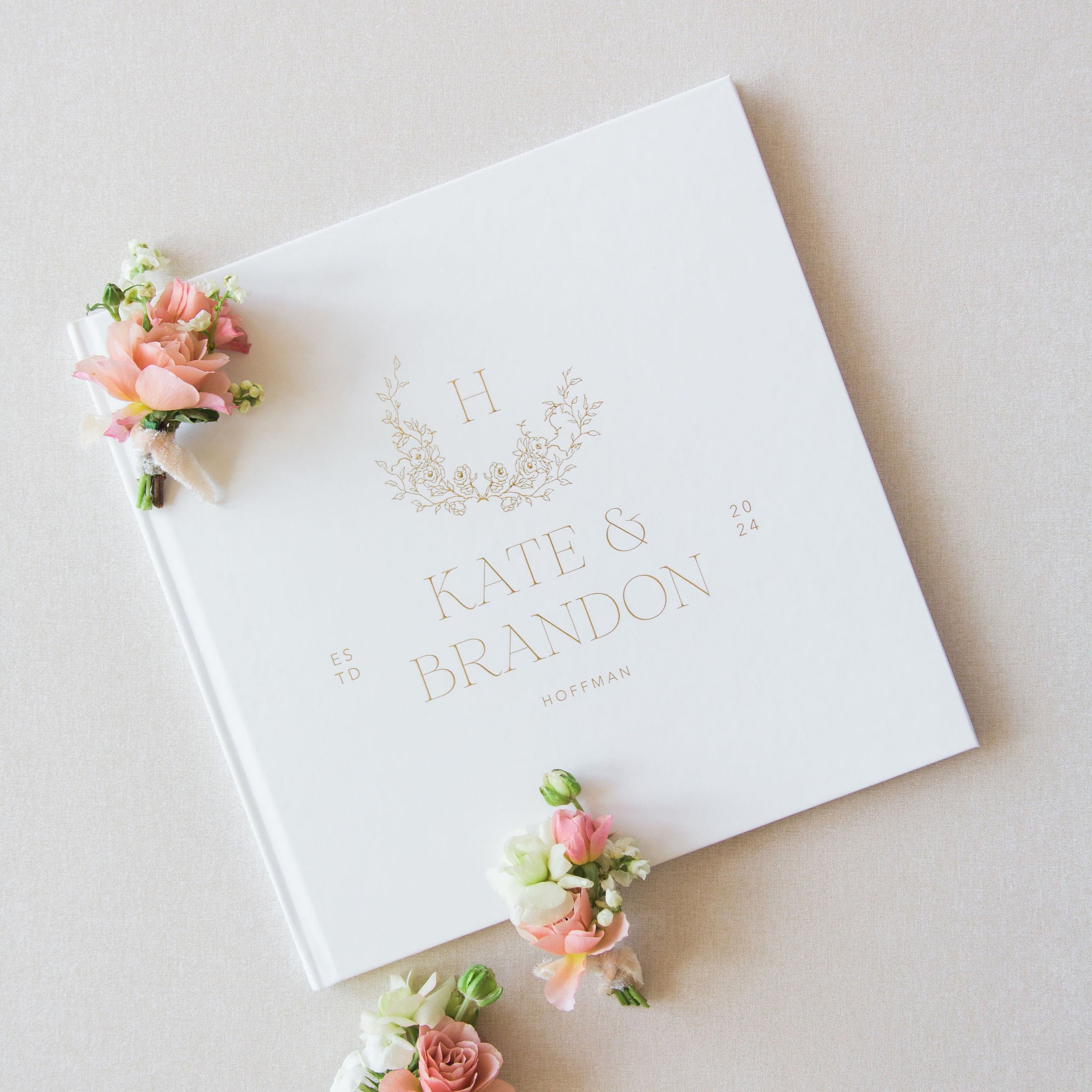 White wedding sign in album with floral decorations on a light background